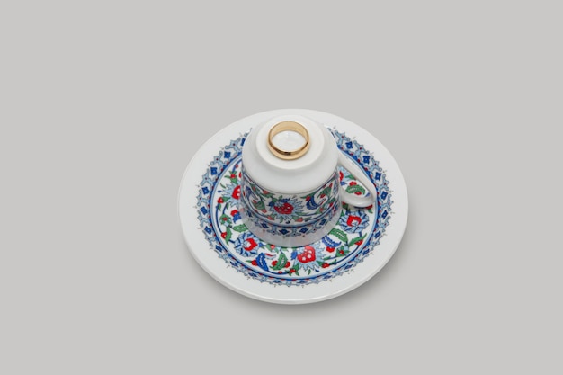 Turkish coffee cup on isolated white background. Preparation for coffee fortune telling. The gold ri