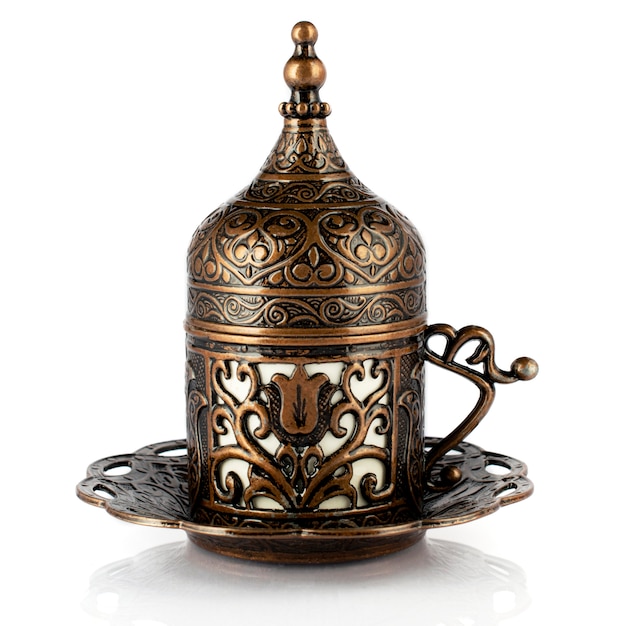 Turkish coffee in traditional copper cookware, a cup of demitass