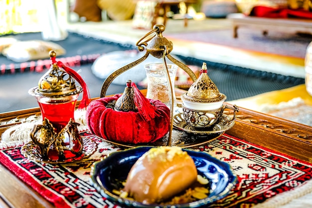 Turkish coffee with delight and traditional copper serving set on retro copper tray