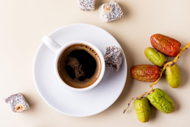 Turkish Delight Lokum and Cup of Turkish Coffee on Yellow Background Tasty Eastern Sweets Dessert