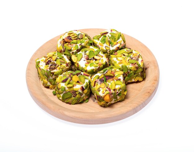 Turkish delight sweets on a wooden stand on a white background