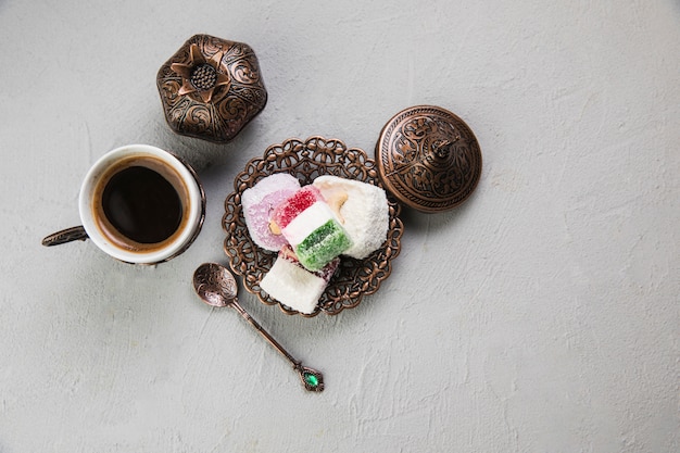 Turkish delight with coffee cup on table