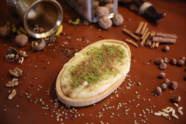 Turkish dessert kunefe, kunafa, kadayif with pistachio powder and cheese hot eaten a sweet