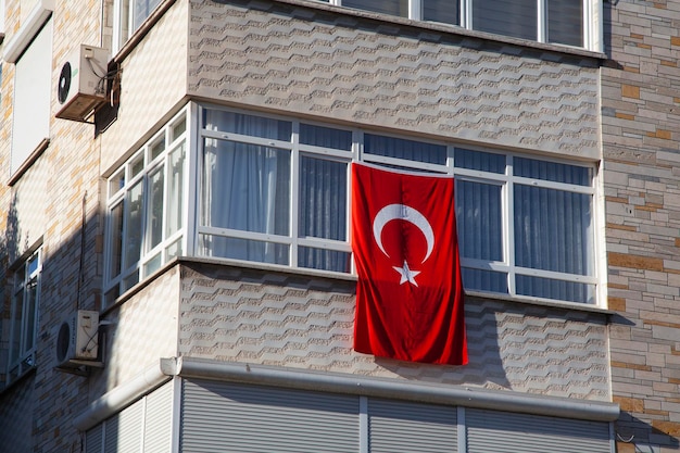 Turkish flag hanging on the window, special day for Turks. Celebration with Turkish flag.