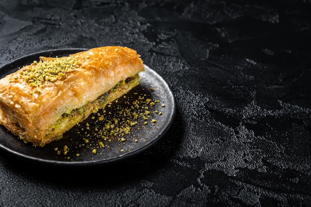 Turkish Havuc Dilim Baklava with pistachio Carrot Slice Baklava Black background Top view Copy space