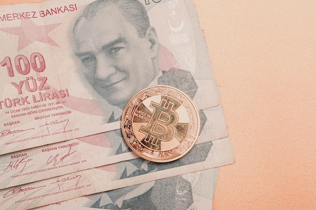 Turkish lira banknotes and bitcoin coin