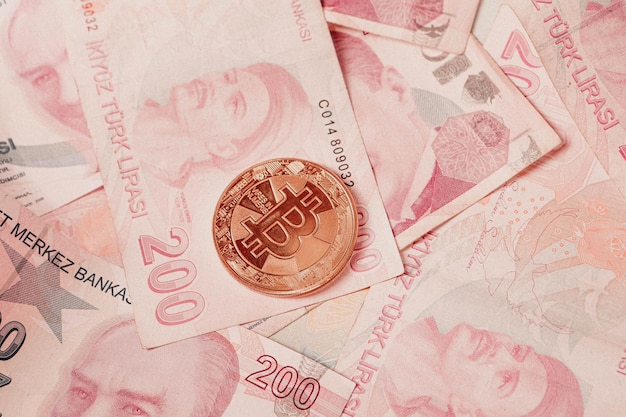 Turkish lira banknotes and bitcoin coin