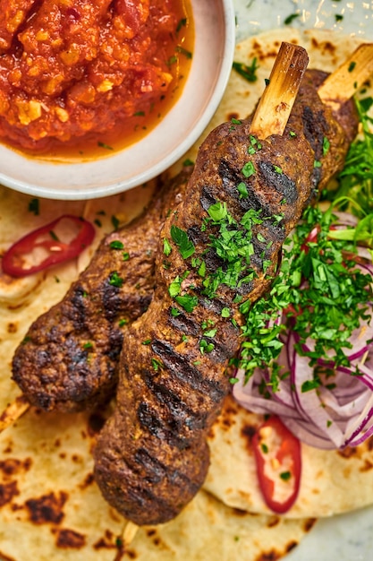 Turkish Lula kebab with pita bread and sauce in a plate