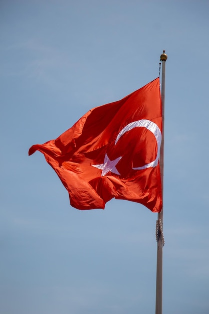 Turkish national flag with white star and moon in sky