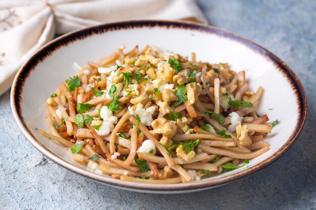 Turkish Noodle Eriste with cheese walnuts and parsley