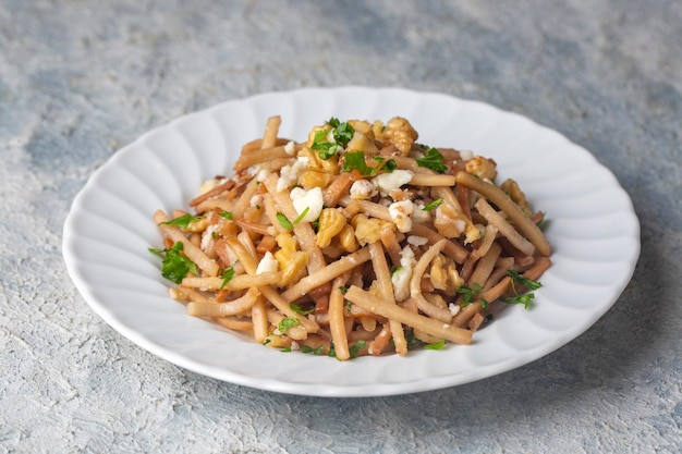 Turkish Noodle Eriste with cheese walnuts and parsley