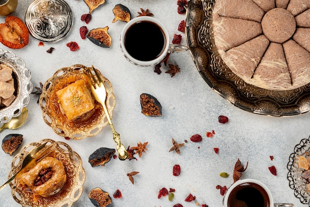 Turkish pastries and scattered dry fruits on table