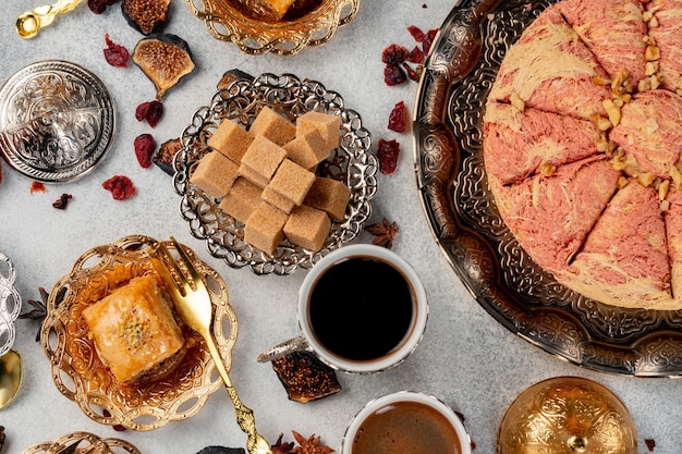 Turkish pastries and scattered dry fruits on table