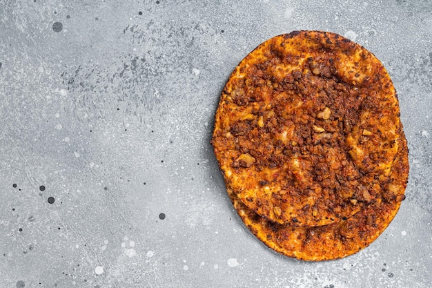 Turkish pizza lahmacun on kitchen table Gray background Top view Copy space