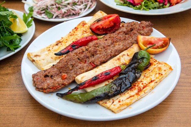 Turkish style Adana Kebab. Traditional Turkish Food Adana Kebab on Wooden Table.