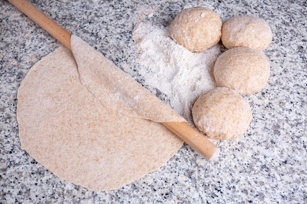 Turkish style making bread with a rolling pin, yeast dough (Turkish name; hamur acmak)