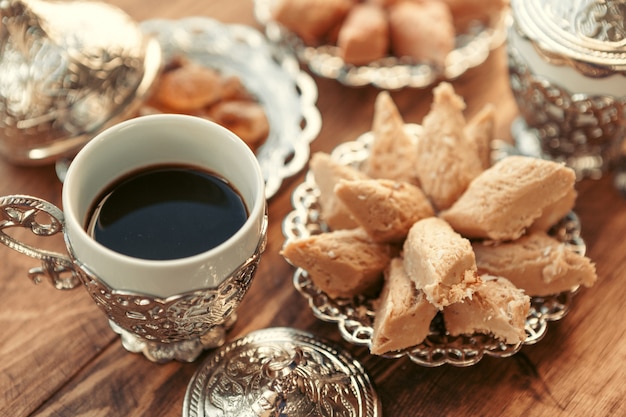 Turkish sweets with coffee on a wooden table