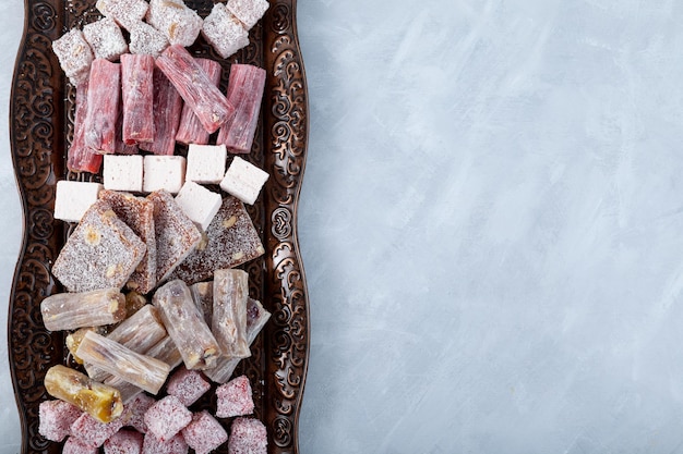 Turkish Sweets with different flavors Turkish Delight on brown metal tray closeup