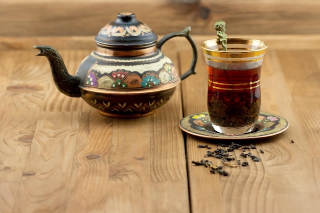 Turkish tea set from a glass cup with a teapot on the table