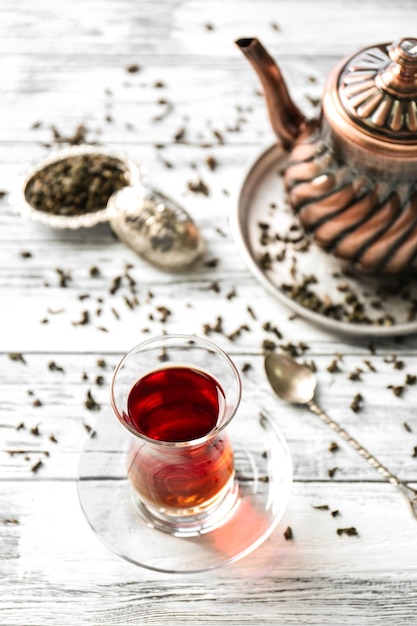 Turkish tea in traditional glass on wooden background