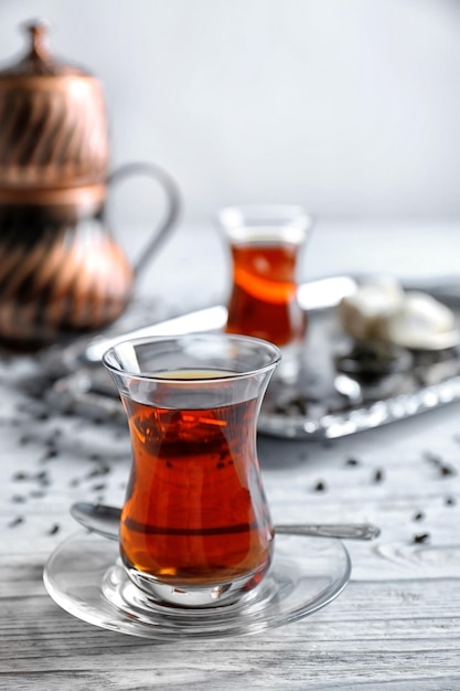 Turkish tea in traditional glass on wooden background