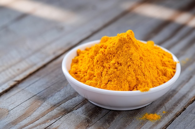 Turmeric powder in white cup.