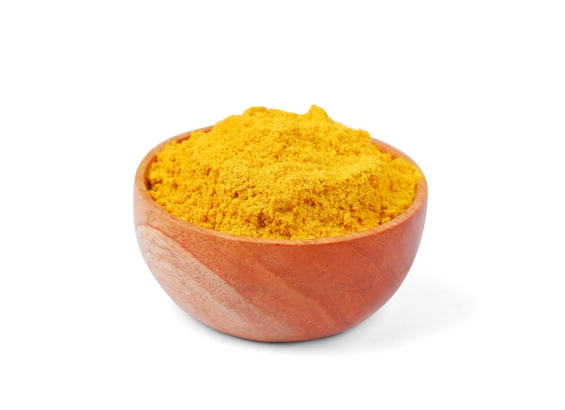 Turmeric powder with wooden bowl isolated on white background