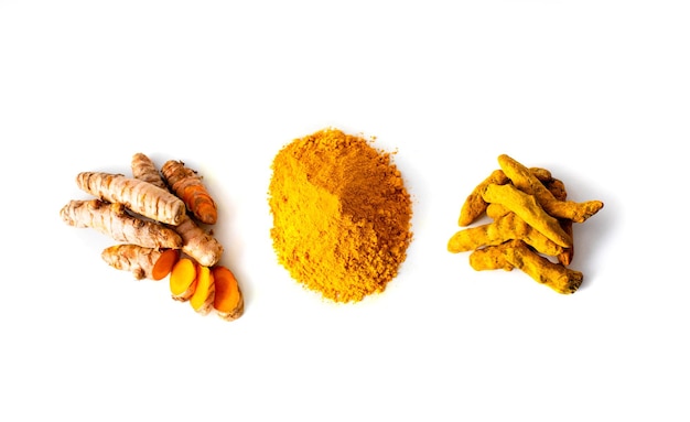 Turmeric rhizome and powder on white background