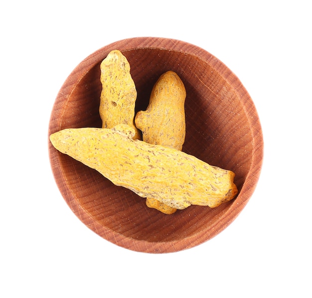 Turmeric root in small wooden bowl isolated on white