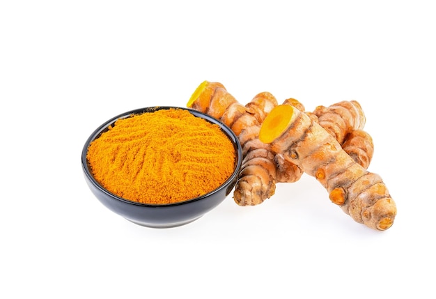 Turmeric roots with turmeric powder isolated on white background