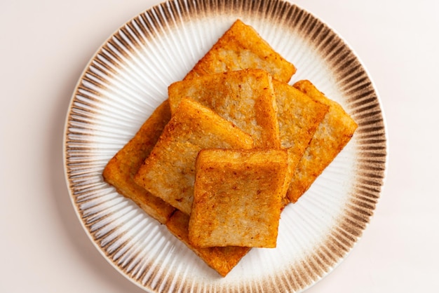 Turnip cake (Chinese  Chai tow kway ). Turnip cake  is a common dish or dim sum of Teochew cuisine.