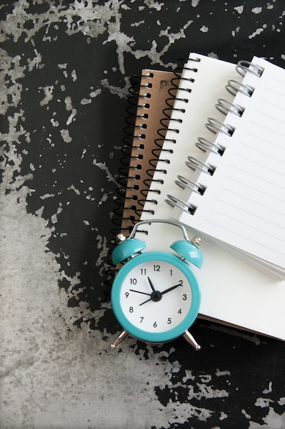 Turquoise alarm clock on black gray