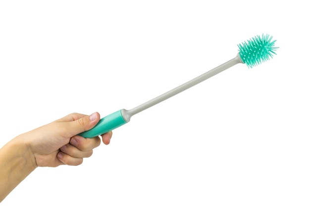 Turquoise bottle washing brush in hand isolated on white surface. Kitchen appliances.