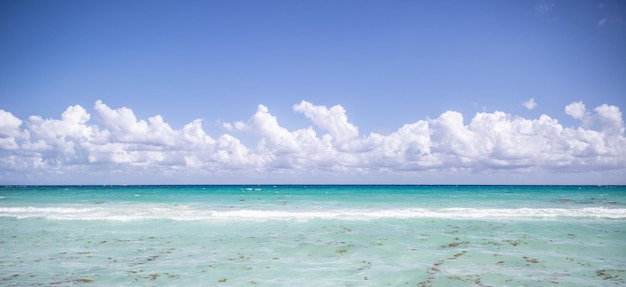 Turquoise dea with clouds on teh horizon as ideal holiday destination for the summer