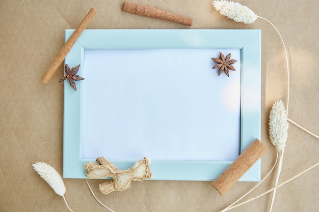 Turquoise frame with place for text frame mock up Cozy home concept Cloves and cinnamon sticks decorations High quality photo