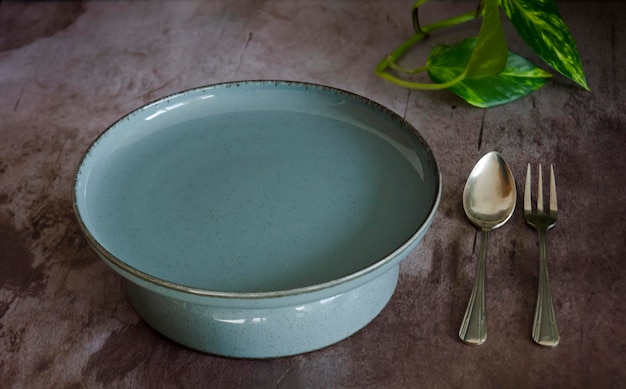 Turquoise round platter next to vintage cutlery