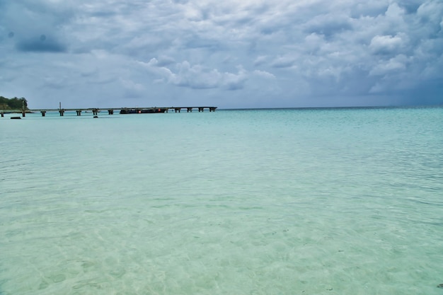 Turquoise water of the Caribbean sea On Blue Sky Vacation Day. A small dock background.