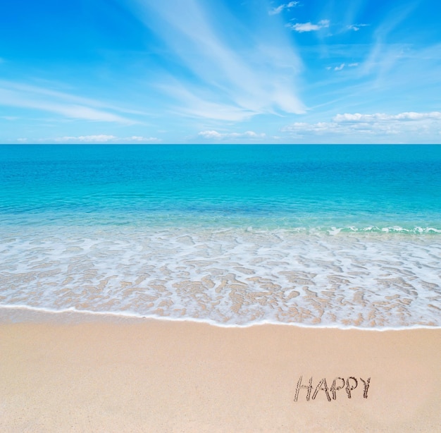 Photo turquoise water and golden sand in sardinia with happy written in the sand on a cloudy day