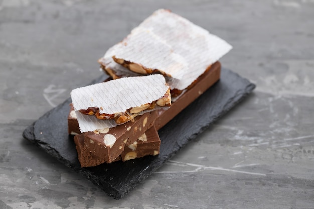 Turron on dark board on ceramic background