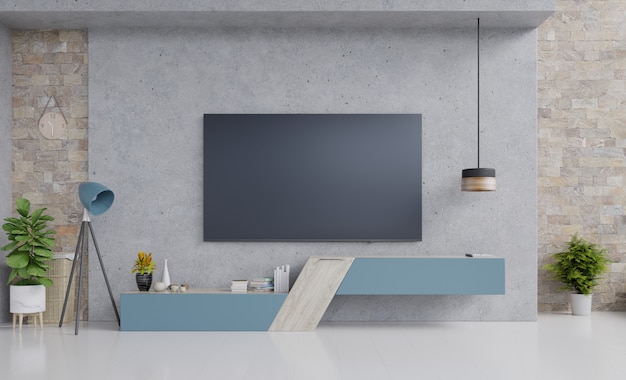 TV on blue cabinet design in modern living room with lamp, flower and plant on cement wall.