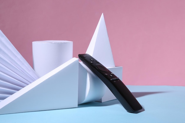 Tv remote and geometric shapes on pink blue background Minimalism Concept art