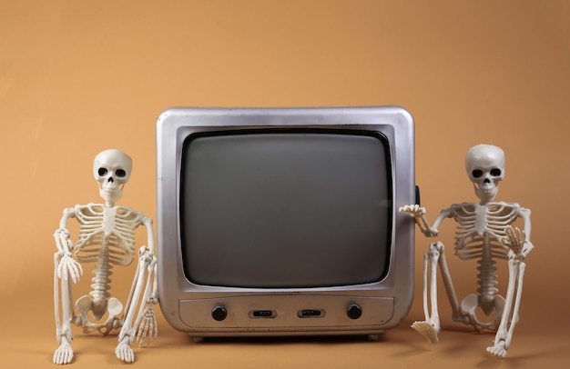 TV and skeletons on a beige background