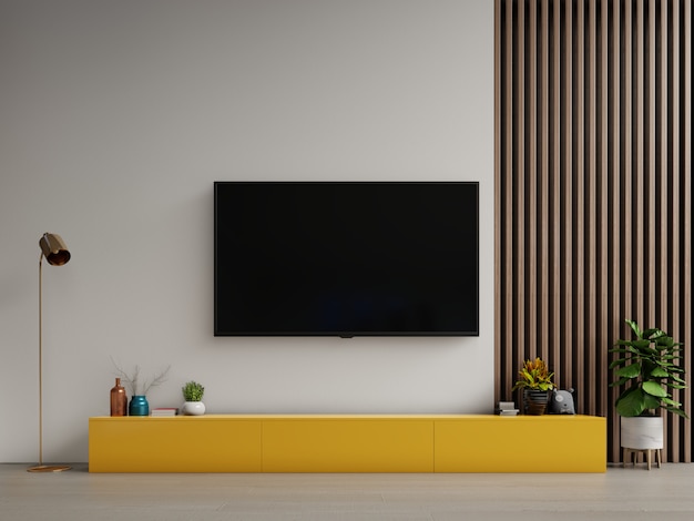 TV on yellow cabinet or place object in modern living room with lamp,table,flower and plant on white wall background.