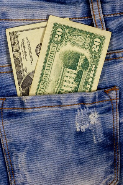 Twenty dollars bill in the pocket of blue jeans