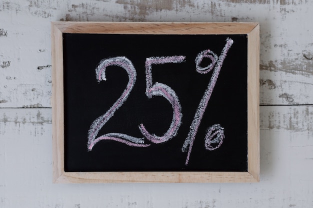 Twenty five percent Discount and special offer Price reduction Blackboard with handwrittent text