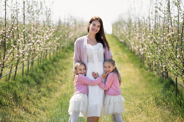 Twin sisters with their beautiful mother on the field