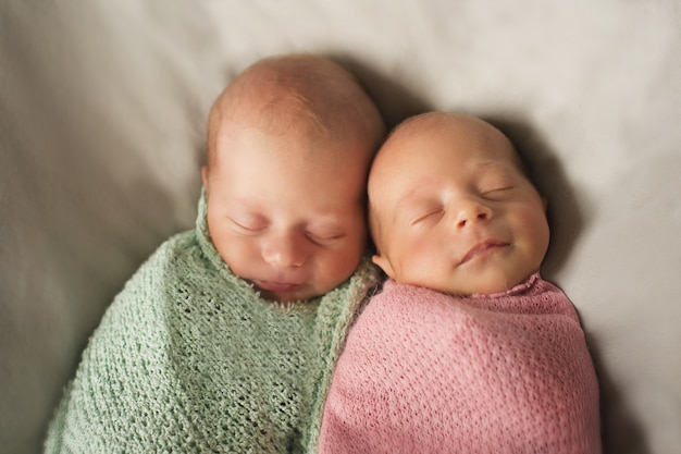 twins embrace. newborn babies sleep together