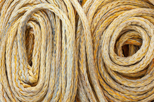 Twisted old synthetic ship's mooring rope closeup