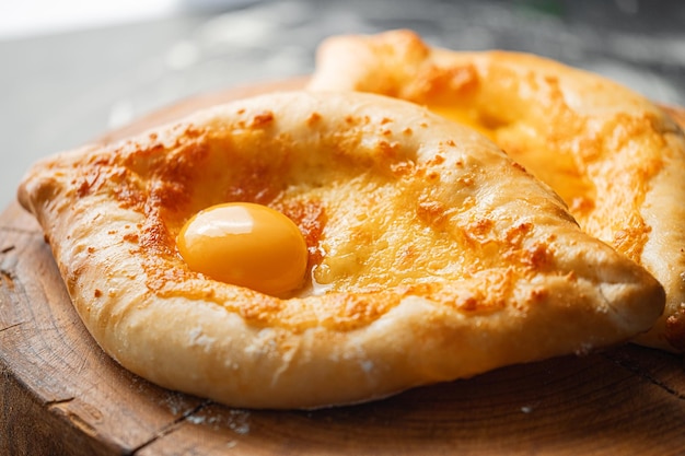 Two Adjarian khachapuri in traditional classic Georgian style