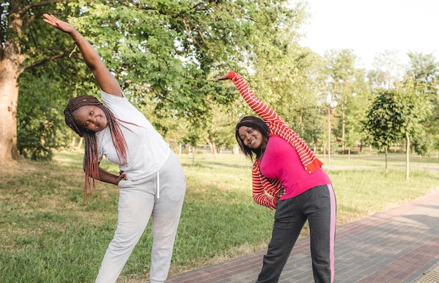 Two African-American girls are engaged in sports, performing various exercises. fitness, yoga, body care. healthy lifestyle